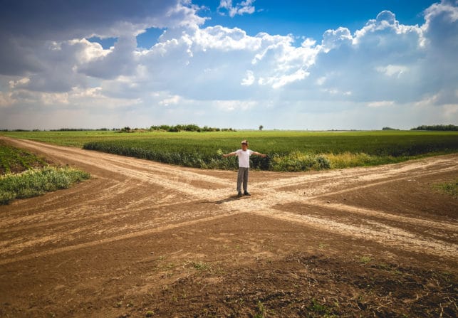 Boy Standing at Crossroad in Path